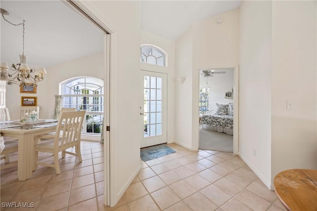 597 Lambton Ln, Naples, FL 34104 - foyer entrance with baseboards, high vaulted ceiling, a chandelier, and light tile patterned flooring