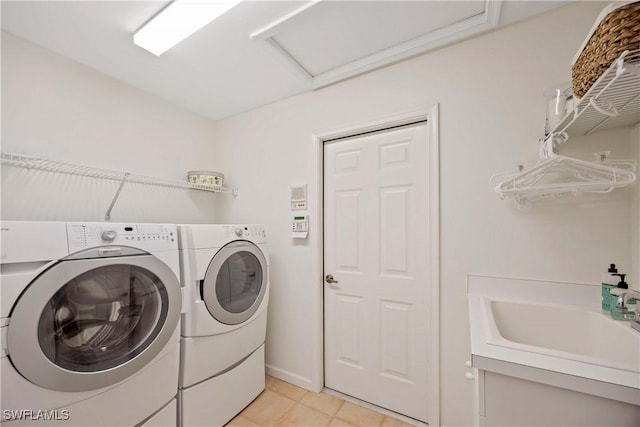 597 Lambton Ln, Naples, FL 34104 - laundry area featuring laundry area, light tile patterned floors, a sink, separate washer and dryer, and attic access
