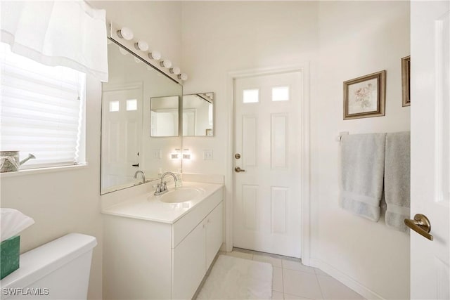 597 Lambton Ln, Naples, FL 34104 - bathroom featuring vanity, toilet, a healthy amount of sunlight, and tile patterned flooring