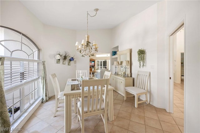 597 Lambton Ln, Naples, FL 34104 - dining area featuring baseboards, a towering ceiling, a chandelier, and light tile patterned floors