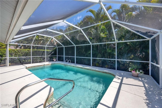 597 Lambton Ln, Naples, FL 34104 - outdoor pool featuring glass enclosure and a patio