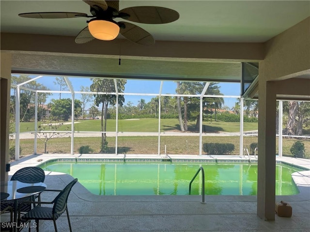 outdoor pool with a patio area, golf course view, glass enclosure, and a ceiling fan
