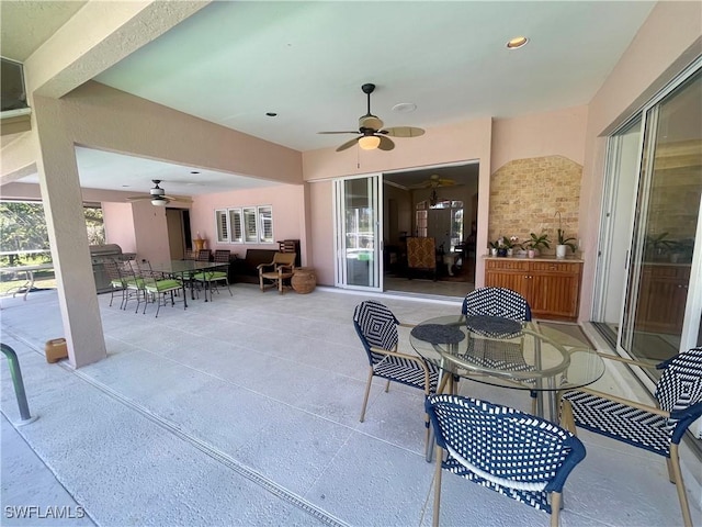 view of patio featuring outdoor dining space and ceiling fan