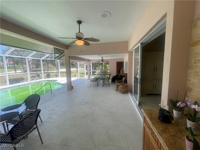 unfurnished sunroom featuring a ceiling fan
