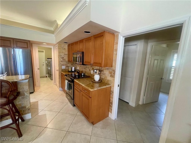 kitchen featuring stainless steel appliances, decorative backsplash, light tile patterned floors, and crown molding