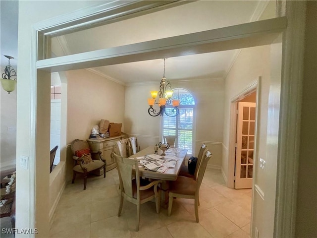 dining room featuring light tile patterned floors, a chandelier, and ornamental molding