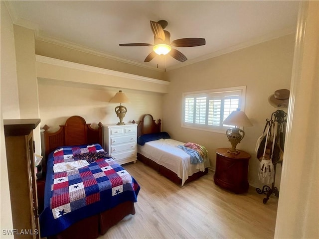 bedroom with a ceiling fan, wood finished floors, and ornamental molding
