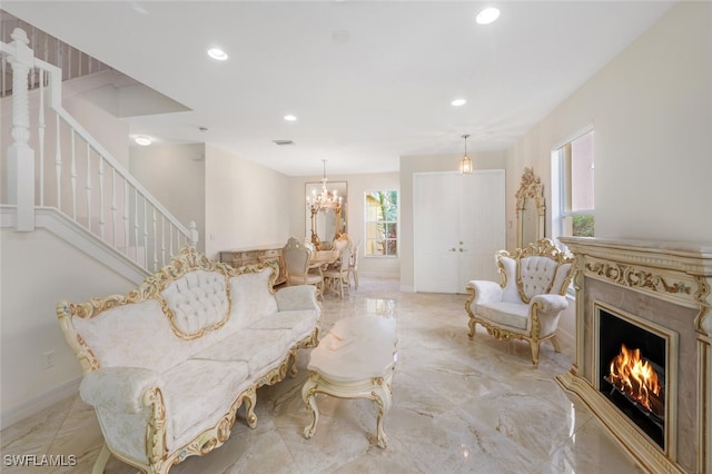 living room featuring plenty of natural light, marble finish floor, stairs, and recessed lighting