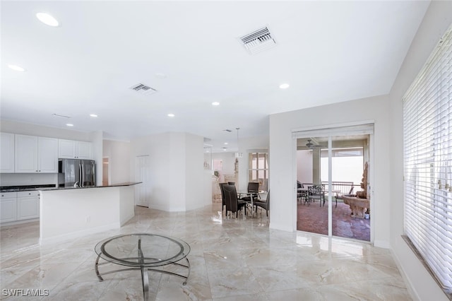 living room with recessed lighting, visible vents, marble finish floor, and baseboards