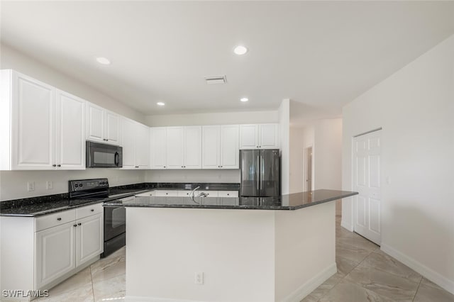 kitchen with marble finish floor, an island with sink, dark stone countertops, black appliances, and white cabinetry