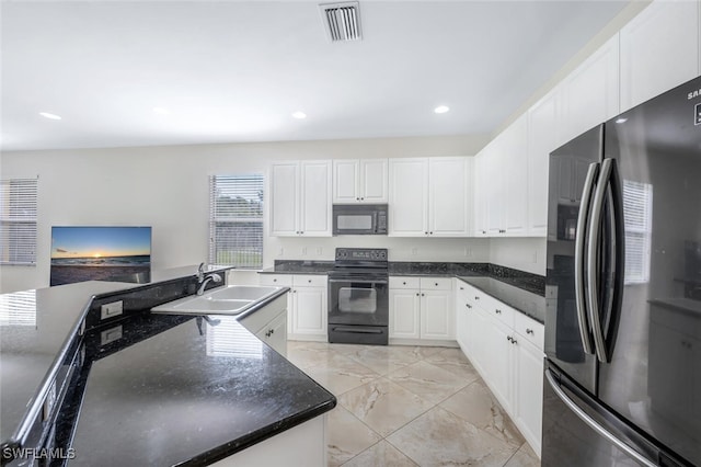 kitchen with black appliances, a sink, visible vents, and white cabinets