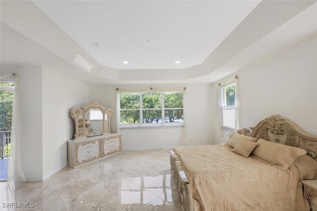 bedroom featuring marble finish floor, baseboards, and a tray ceiling