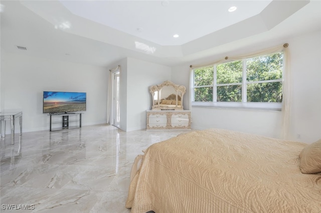 bedroom featuring a tray ceiling, visible vents, and marble finish floor
