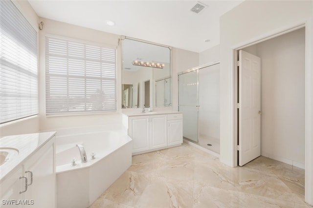 full bath featuring two vanities, a stall shower, visible vents, marble finish floor, and a garden tub