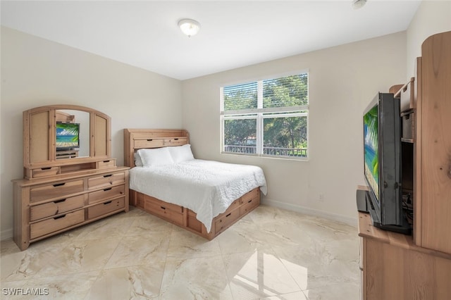 bedroom with baseboards and marble finish floor