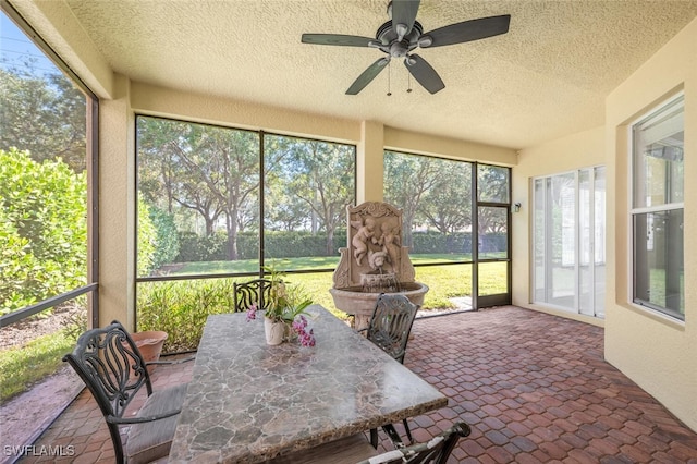 sunroom with a ceiling fan