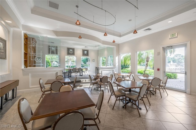 tiled dining room with baseboards, crown molding, a tray ceiling, and visible vents