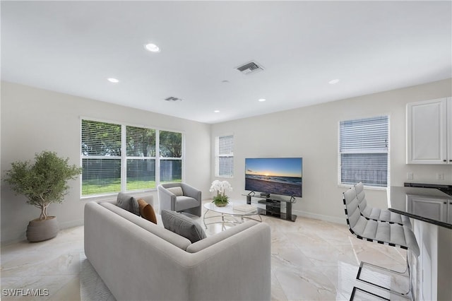 living room with recessed lighting, visible vents, and marble finish floor