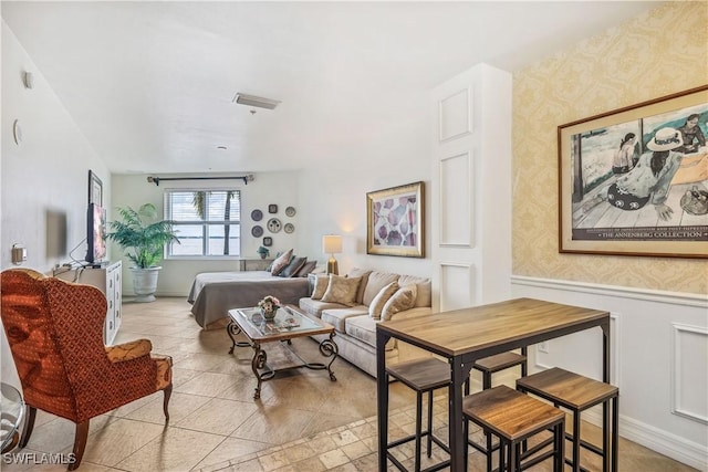 2797 1st St Unit 2003, Fort Myers, FL 33916 - living area featuring wallpapered walls, a wainscoted wall, and visible vents