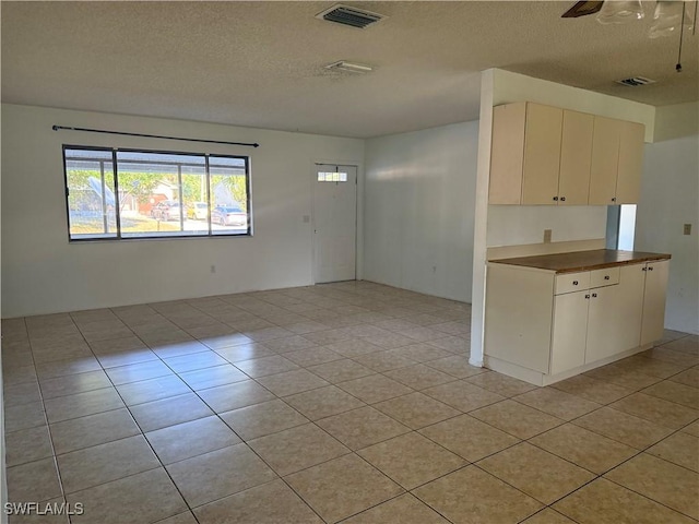 4004 Sena Ln, Labelle, FL 33935 - kitchen with visible vents, a textured ceiling, and light tile patterned floors
