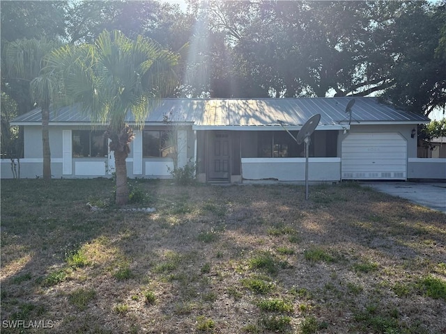 4004 Sena Ln, Labelle, FL 33935 - view of front of home with concrete driveway, an attached garage, a front yard, and metal roof