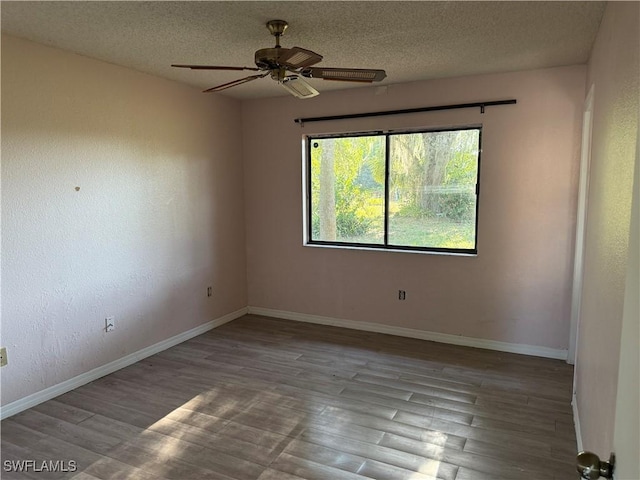4004 Sena Ln, Labelle, FL 33935 - empty room featuring baseboards, a ceiling fan, wood finished floors, and a textured ceiling