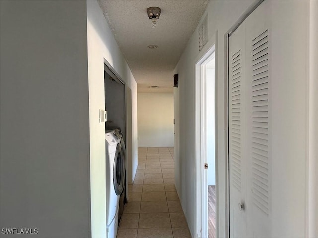 4004 Sena Ln, Labelle, FL 33935 - corridor featuring washing machine and clothes dryer, a textured ceiling, visible vents, and light tile patterned floors