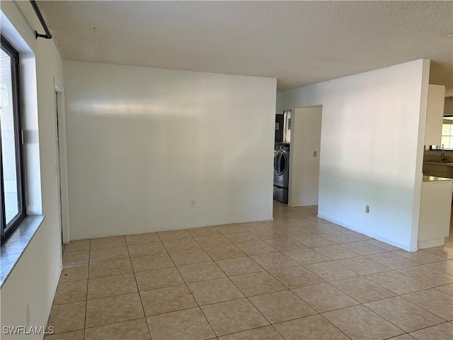 4004 Sena Ln, Labelle, FL 33935 - empty room with washer / dryer, light tile patterned flooring, a sink, and plenty of natural light