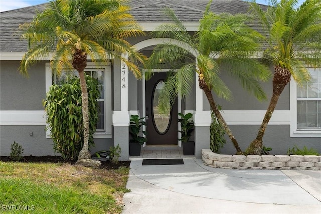 2748 45th Ave NE, Naples, FL 34120 - entrance to property featuring stucco siding and a shingled roof