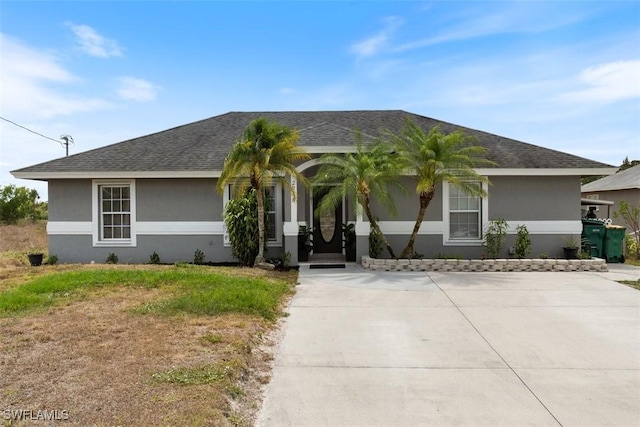 2748 45th Ave NE, Naples, FL 34120 - ranch-style home with a front lawn, stucco siding, and roof with shingles