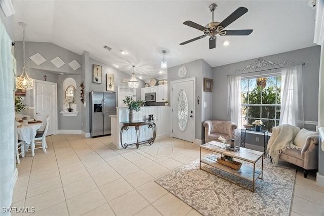 2748 45th Ave NE, Naples, FL 34120 - living area featuring lofted ceiling, light tile patterned floors, visible vents, baseboards, and a ceiling fan