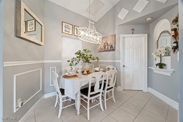 2748 45th Ave NE, Naples, FL 34120 - tiled dining area featuring baseboards and a notable chandelier