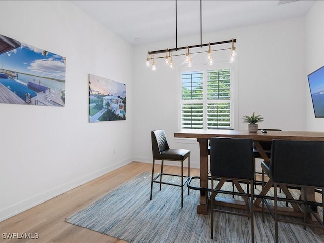 201 S Heathwood Dr, Marco Island, FL 34145 - dining room featuring baseboards and wood finished floors