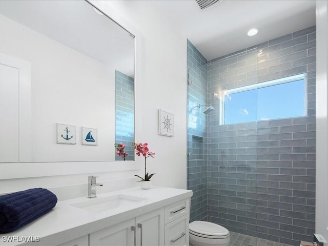201 S Heathwood Dr, Marco Island, FL 34145 - bathroom with visible vents, toilet, vanity, and tiled shower