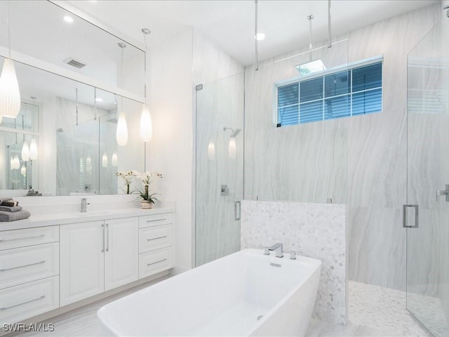 201 S Heathwood Dr, Marco Island, FL 34145 - bathroom featuring vanity, visible vents, a soaking tub, and a marble finish shower