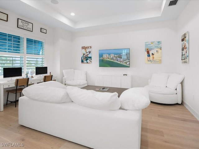 201 S Heathwood Dr, Marco Island, FL 34145 - living room featuring a raised ceiling, radiator heating unit, visible vents, and light wood-type flooring