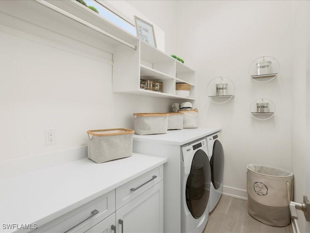 201 S Heathwood Dr, Marco Island, FL 34145 - laundry room featuring washer and dryer, baseboards, cabinet space, and light wood-style flooring