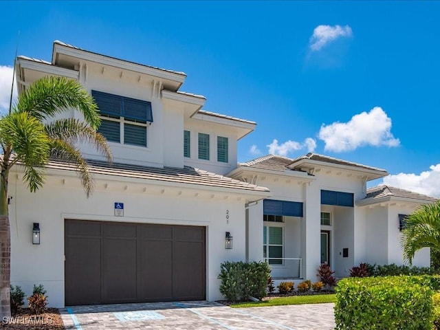 201 S Heathwood Dr, Marco Island, FL 34145 - view of front of property featuring stucco siding, decorative driveway, and a garage