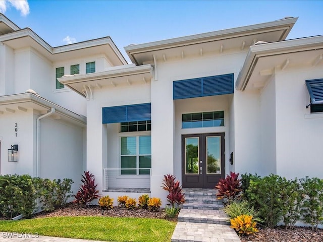 201 S Heathwood Dr, Marco Island, FL 34145 - property entrance with stucco siding and french doors