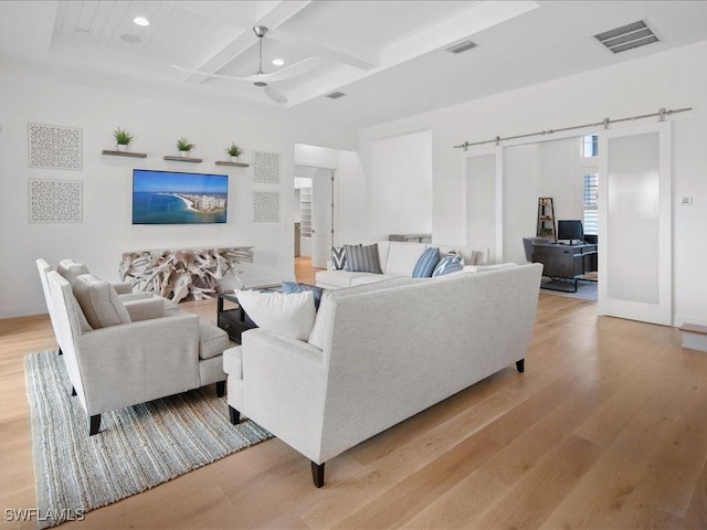 201 S Heathwood Dr, Marco Island, FL 34145 - living room featuring a barn door, a ceiling fan, visible vents, and light wood-type flooring