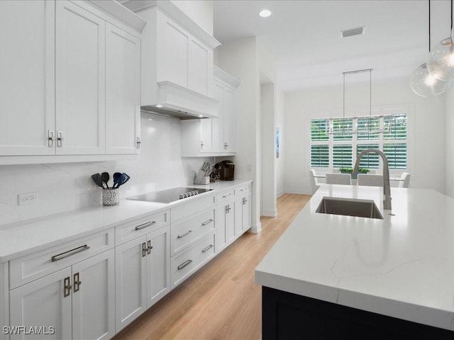 201 S Heathwood Dr, Marco Island, FL 34145 - kitchen featuring white cabinets, a sink, visible vents, decorative backsplash, and black electric stovetop