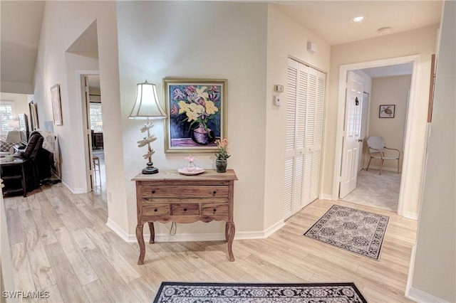 corridor featuring baseboards and wood finished floors