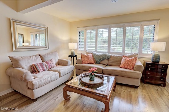living area with light wood finished floors and baseboards