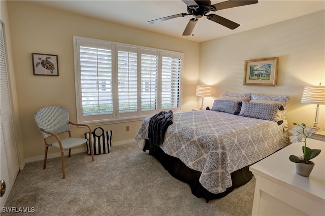 carpeted bedroom featuring baseboards and ceiling fan