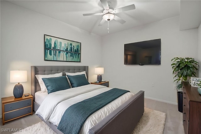 carpeted bedroom featuring baseboards and ceiling fan