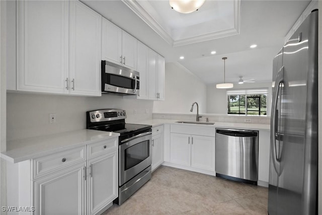 kitchen with white cabinets, stainless steel appliances, a sink, crown molding, and light countertops