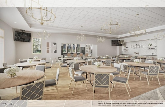 dining room featuring a raised ceiling, wood finished floors, and a notable chandelier