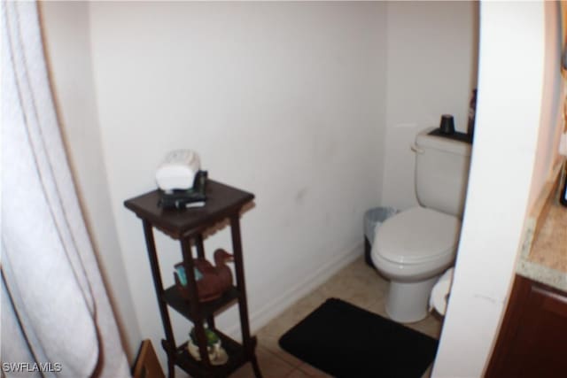 509 SW 28th St, Cape Coral, FL 33914 - bathroom featuring baseboards and toilet