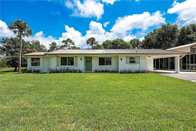 27525 Michigan St, Bonita Springs, FL 34135 - view of front of property with concrete driveway, a front lawn, a carport, and metal roof