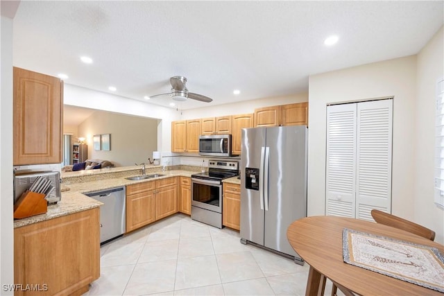 733 Landover Ct Unit 203, Naples, FL 34104 - kitchen with a sink, recessed lighting, appliances with stainless steel finishes, light stone counters, and light tile patterned floors
